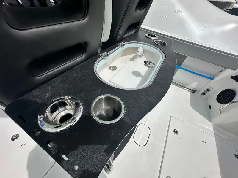 Slide: The Image of 2025 Sea Pro 292 Offshore boat interior with sink and cup holders. - 17