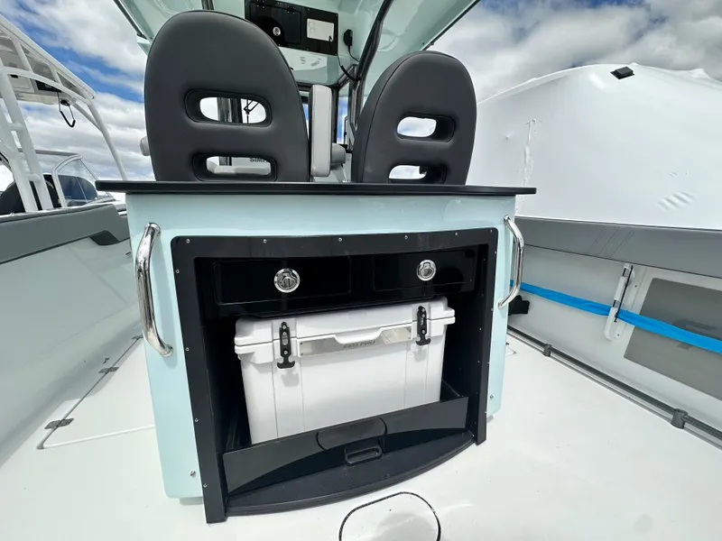 Slide: The Image of 2025 Sea Pro 292 Offshore boat interior with storage compartment and cooler. - 18