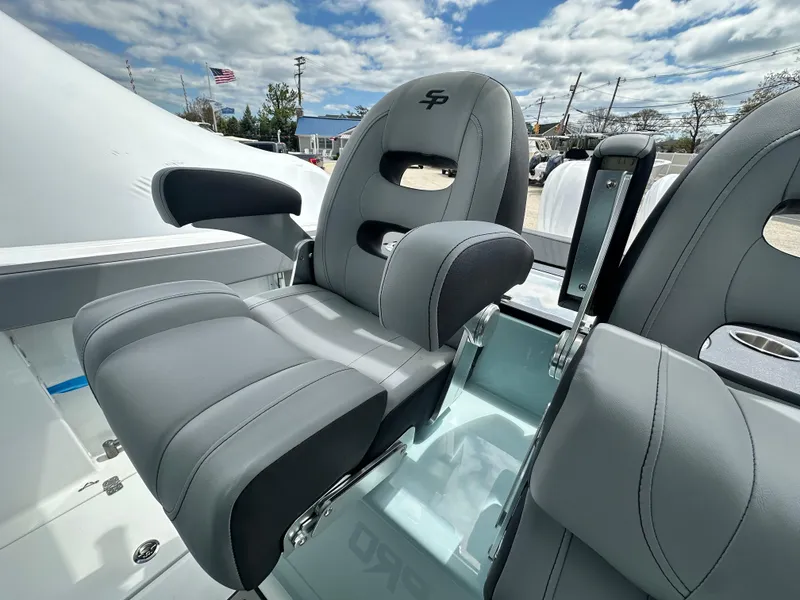 Slide: The Image of 2025 Sea Pro 292 Offshore boat seat, gray upholstery, armrests, outdoor setting, cloudy sky. - 19