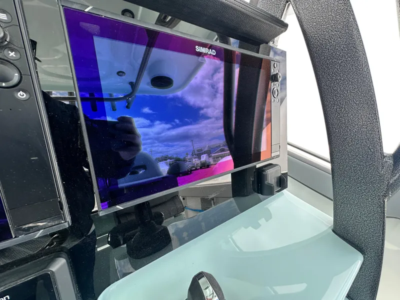 Slide: The Image of Simrad display on 2025 Sea Pro 292 Offshore boat, showing vibrant sky reflection. - 25