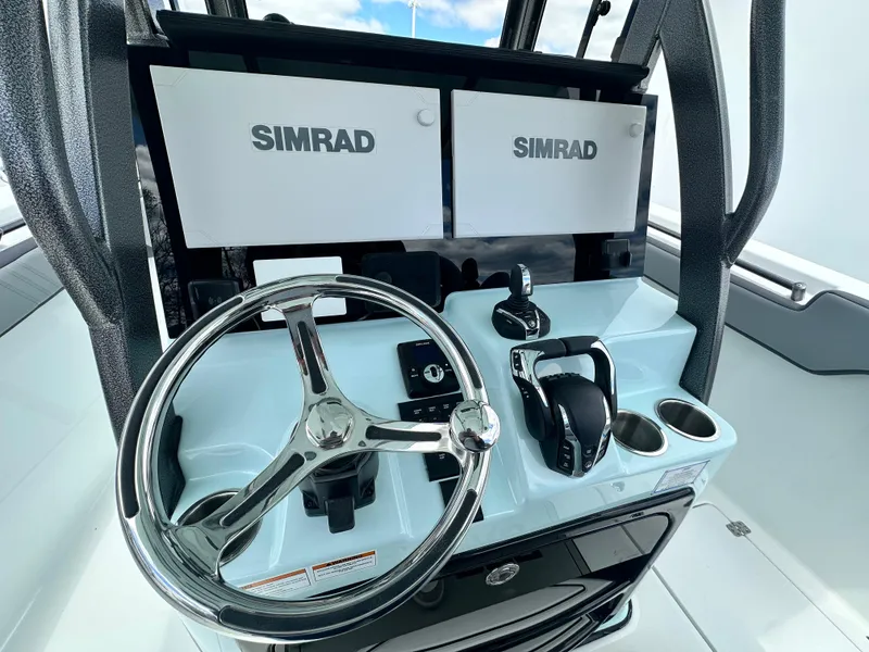 Slide: The Image of 2025 Sea Pro 292 Offshore helm with dual Simrad displays and modern controls. - 29
