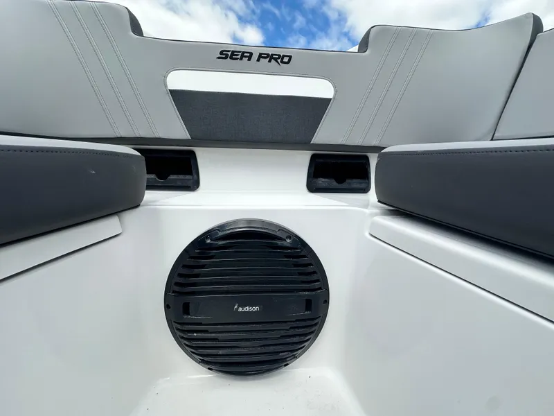 Slide: The Image of 2025 Sea Pro 292 Offshore boat interior with Fusion speaker and cushioned seating. - 34