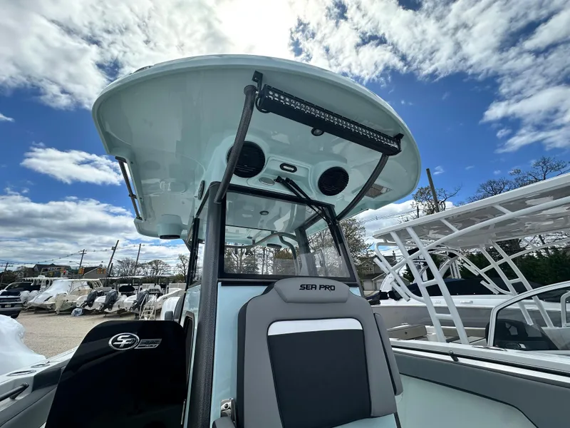 Slide: The Image of 2025 Sea Pro 292 Offshore boat with T-top under a partly cloudy sky. - 35