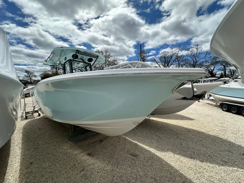Slide: The Image of 2025 Sea Pro 292 Offshore boat under cloudy sky, parked on gravel. - 4