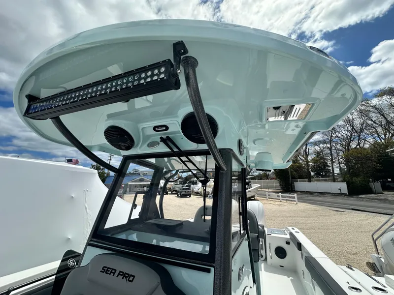 Slide: The Image of 2025 Sea Pro 292 Offshore boat with advanced features and sleek design under a cloudy sky. - 42