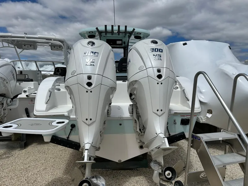 Slide: The Image of 2025 Sea Pro 292 Offshore boat with dual 300 V6 engines, docked under cloudy skies. - 7