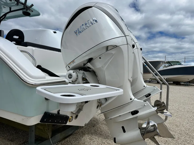 Slide: The Image of 2025 Sea Pro 292 Offshore boat with dual Yamaha outboard engines, parked on gravel. - 8