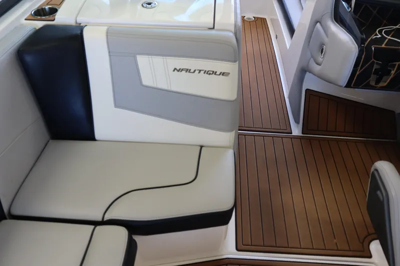Slide: The Image of 2020 Nautique Super Air Nautique 230 interior with sleek seating and teak-style flooring. - 12