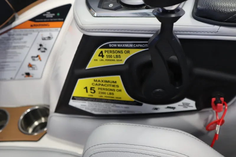 Slide: The Image of 2020 Nautique Super Air Nautique 230 dashboard with capacity labels and controls. - 19