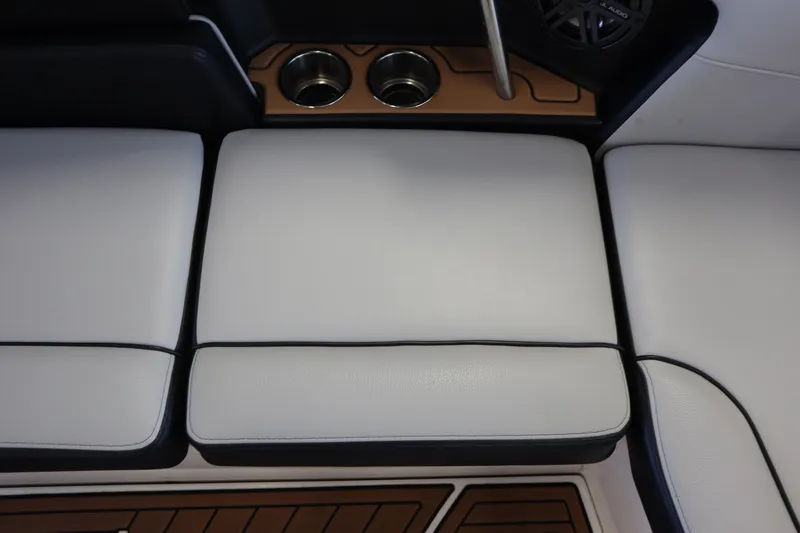 Slide: The Image of 2020 Nautique Super Air Nautique 230 interior seating with cup holders and speaker. - 22