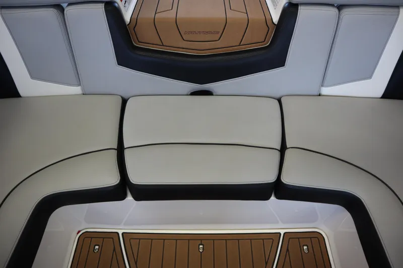 Slide: The Image of 2020 Nautique Super Air Nautique 230 interior seating with sleek, modern design and cushioned seats. - 27