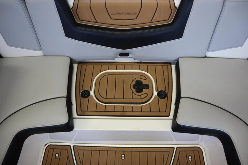 Slide: The Image of 2020 Nautique Super Air Nautique 230 interior deck with tan and black accents. - 28
