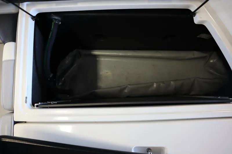 Slide: The Image of 2020 Nautique Super Air Nautique 230 storage compartment with ballast bag. - 34