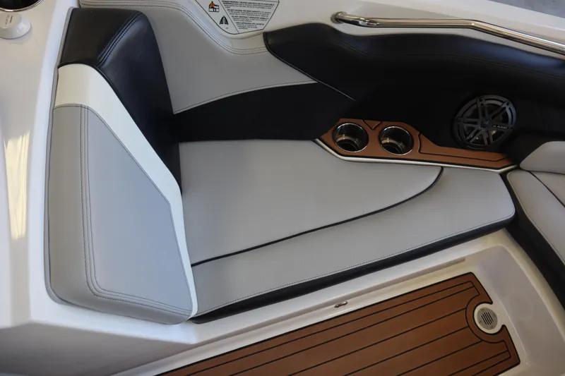Slide: The Image of 2020 Nautique Super Air Nautique 230 interior seating with cup holders and speaker. - 5