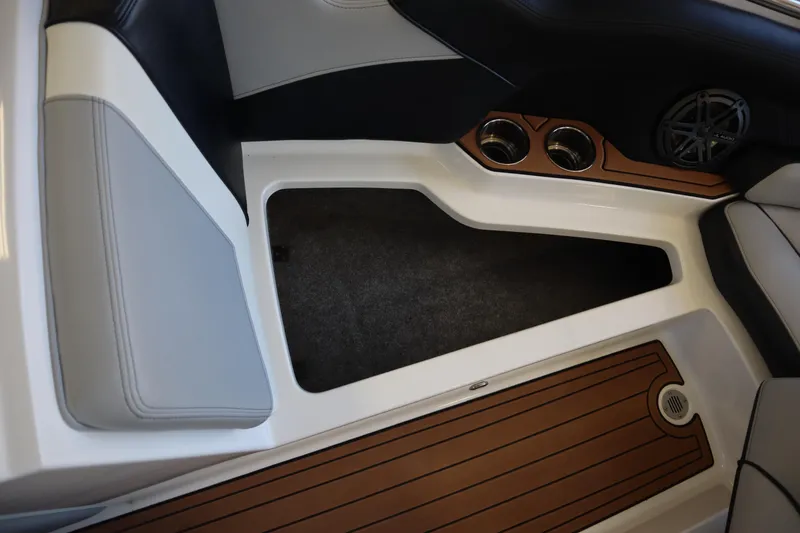 Slide: The Image of 2020 Nautique Super Air Nautique 230 interior with cup holders and wood-style flooring. - 6