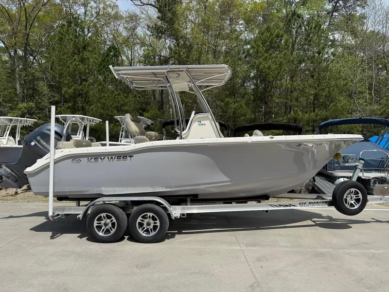 Slide: The Image of 2022 Key West 219 FS boat on trailer, parked outdoors. - 1
