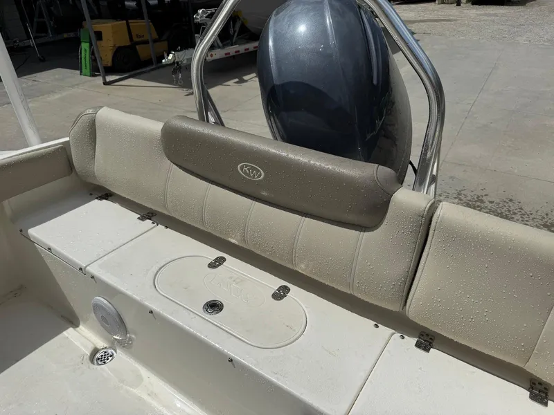 Slide: The Image of 2022 Key West 219 FS boat interior with cushioned seating and storage compartment. - 10