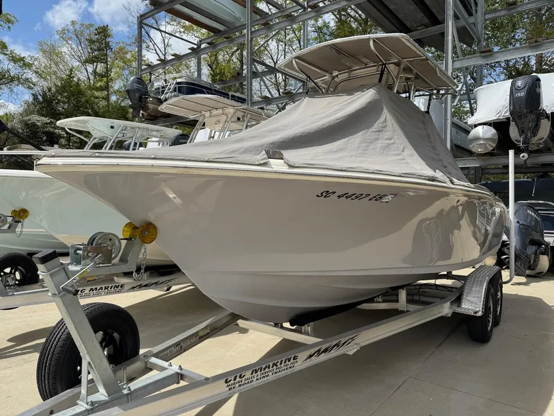 Slide: The Image of 2022 Key West 219 FS boat on trailer, covered, in a marina storage area. - 14