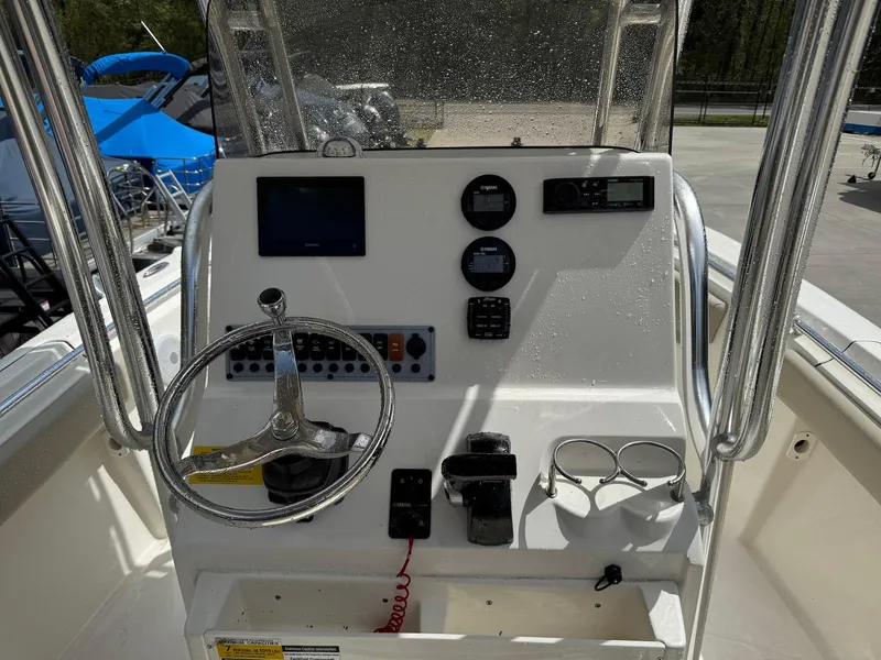 Slide: The Image of 2022 Key West 219 FS boat console with steering wheel and navigation instruments. - 6
