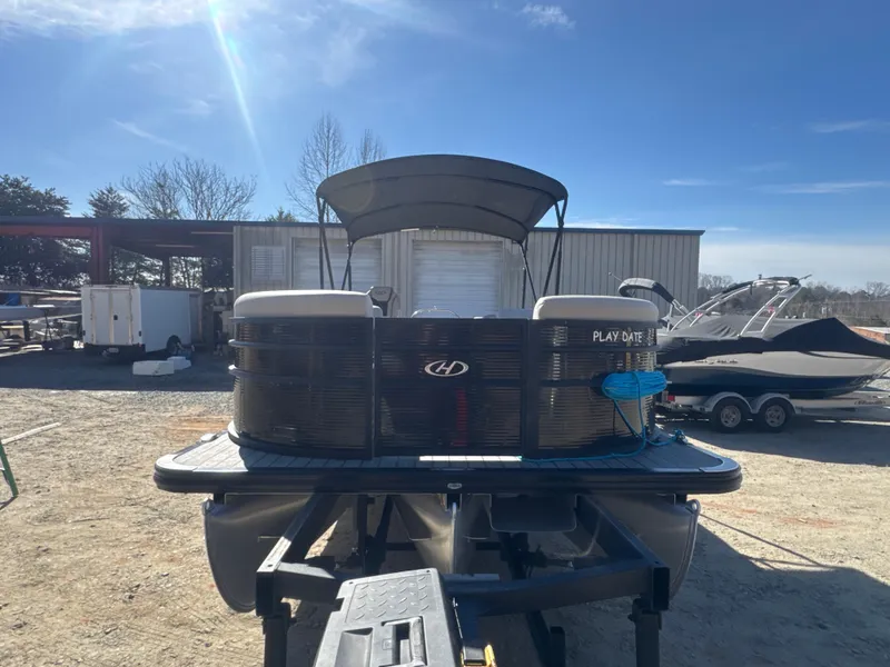 Slide: The Image of 2023 Harris HCX230 SL pontoon boat on trailer under clear blue sky. - 10