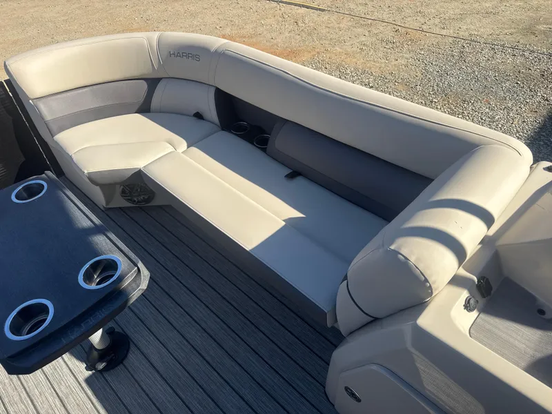 Slide: The Image of 2023 Harris HCX230 SL boat interior with beige seating and cup holders. - 14