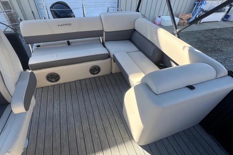 Slide: The Image of 2023 Harris HCX230 SL boat interior with beige seating and integrated speakers. - 20