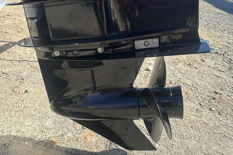 Slide: The Image of 2023 Harris HCX230 SL boat motor propeller on a gravel surface. - 25