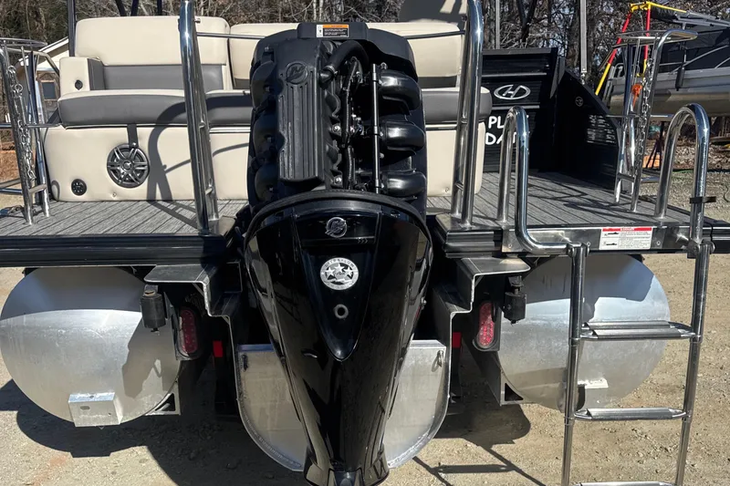 Slide: The Image of 2023 Harris HCX230 SL pontoon boat with powerful outboard motor and spacious seating. - 26