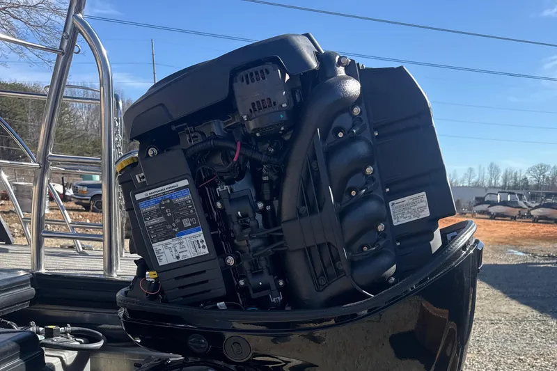 Slide: The Image of 2023 Harris HCX230 SL boat engine, detailed view, outdoors, sunny day. - 28