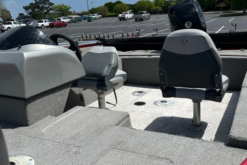 Slide: The Image of 2012 Tracker Pro Guide V-175 SC boat interior with seating in a parking lot. - 2