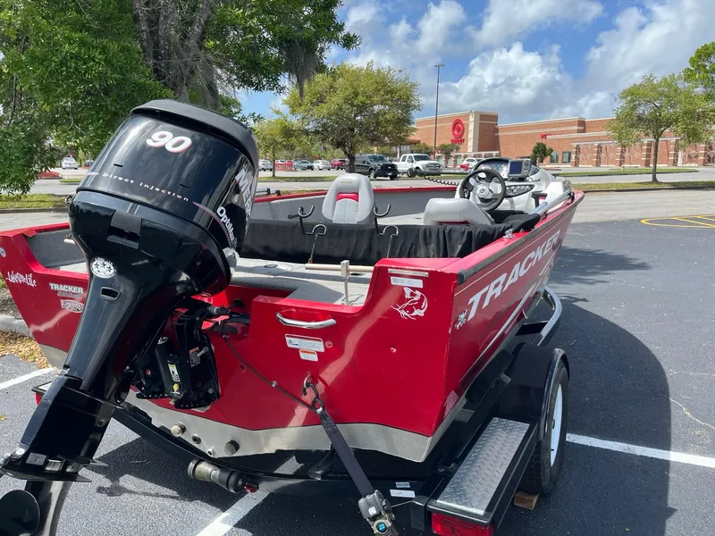 Slide: The Image of 2012 Tracker Pro Guide V-175 SC boat with 90 HP engine in parking lot. - 5