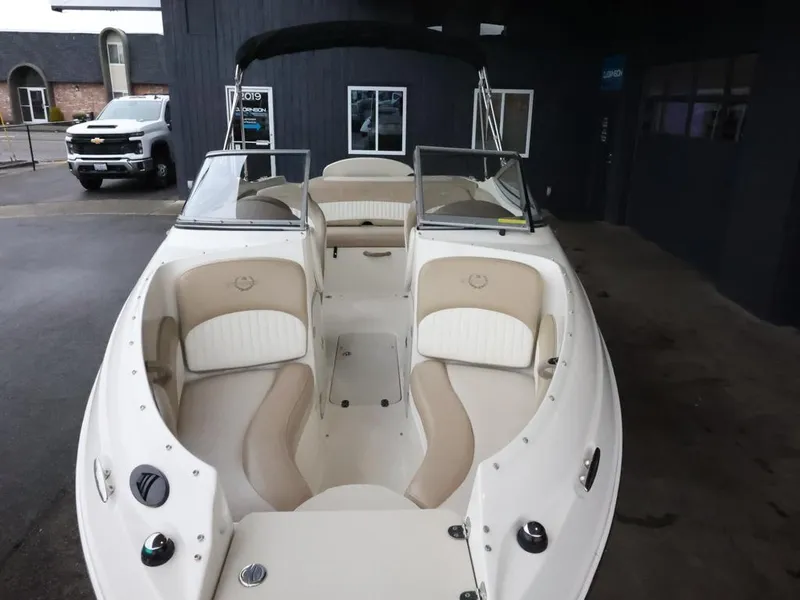 Slide: The Image of 2015 Stingray 198LX boat with beige and white interior, parked indoors. - 13