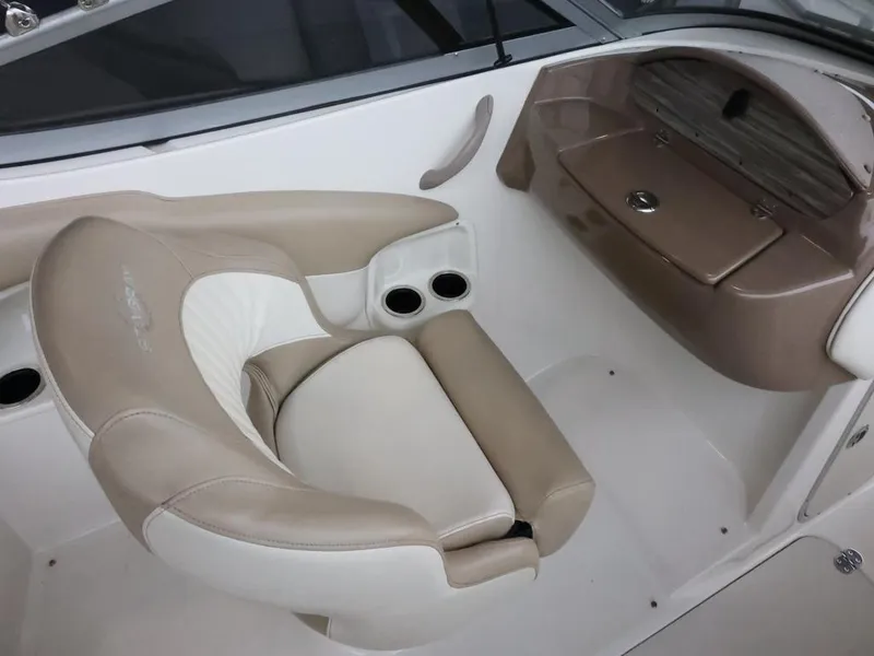 Slide: The Image of 2015 Stingray 198LX boat interior with beige seating and cup holders. - 17