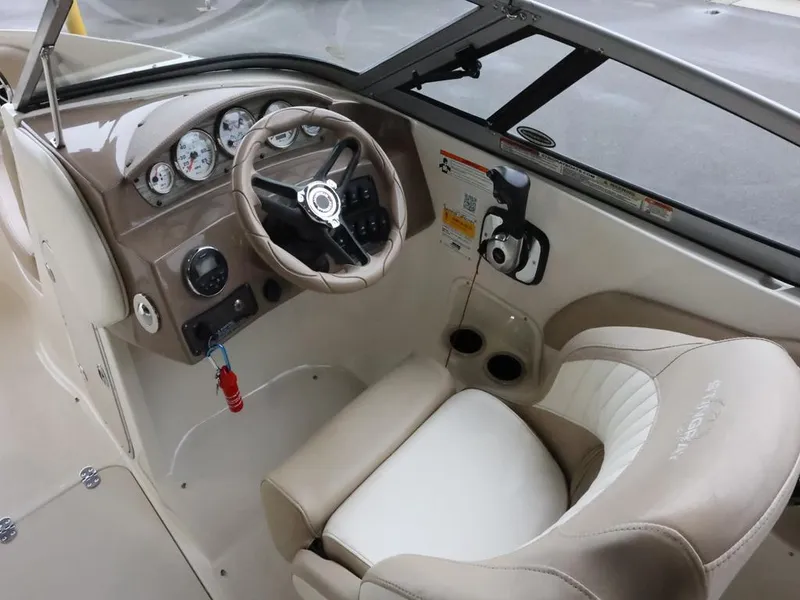 Slide: The Image of 2015 Stingray 198LX boat interior with steering wheel and dashboard controls. - 18