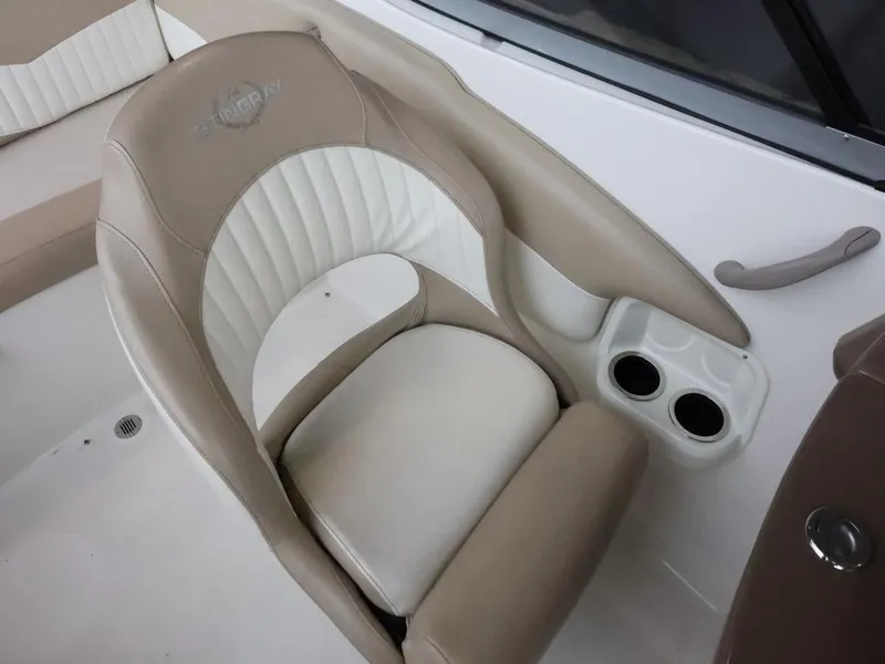 Slide: The Image of 2015 Stingray 198LX boat seat with beige and white upholstery, featuring dual cup holders. - 20