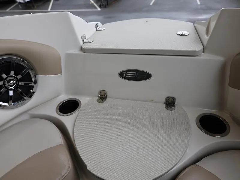 Slide: The Image of 2015 Stingray 198LX boat interior with cup holders and speaker. - 23