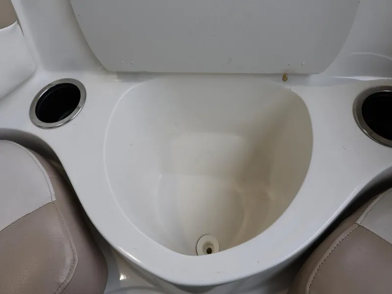 Slide: The Image of Interior of 2015 Stingray 198LX boat with cup holders and storage compartment. - 24