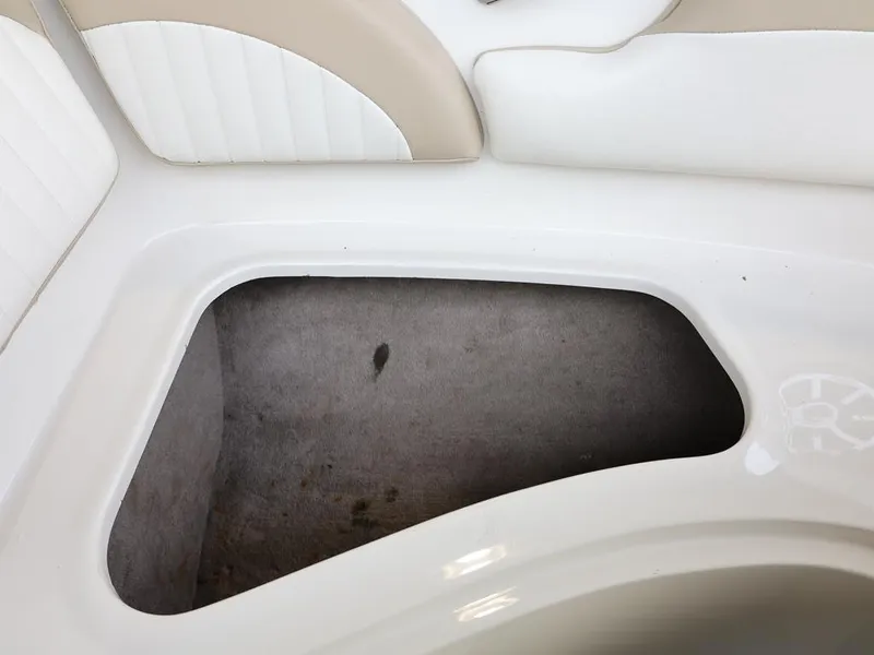 Slide: The Image of 2015 Stingray 198LX boat storage compartment with white and beige seating. - 25