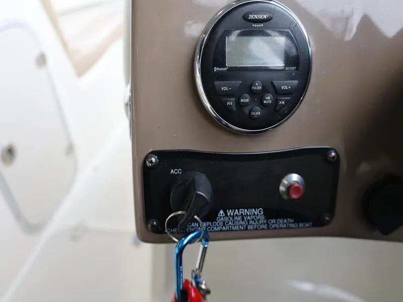 Slide: The Image of Control panel of a 2015 Stingray 198LX boat with Jensen stereo system. - 29