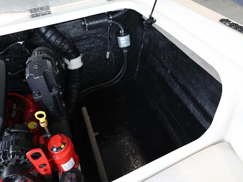 Slide: The Image of Engine compartment of a 2015 Stingray 198LX boat, showcasing mechanical components. - 35