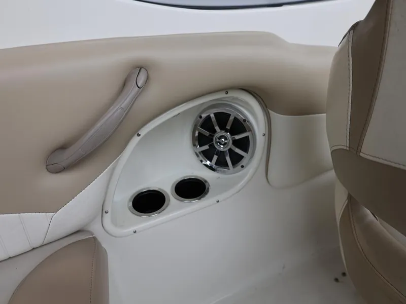 Slide: The Image of Interior of a 2015 Stingray 198LX boat featuring speaker and cup holders. - 37