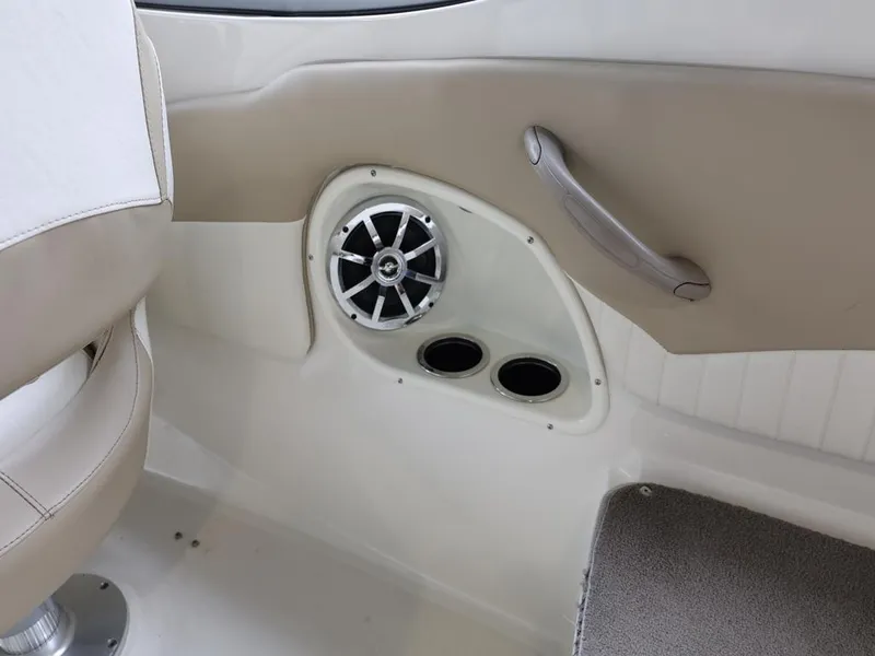 Slide: The Image of Interior of a 2015 Stingray 198LX boat featuring speaker and cup holders. - 38