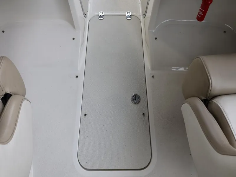 Slide: The Image of Interior view of a 2015 Stingray 198LX boat, featuring beige seating and storage compartment. - 39