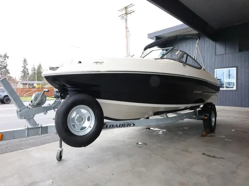 Slide: The Image of 2015 Stingray 198LX boat on trailer, parked under a shelter. - 4