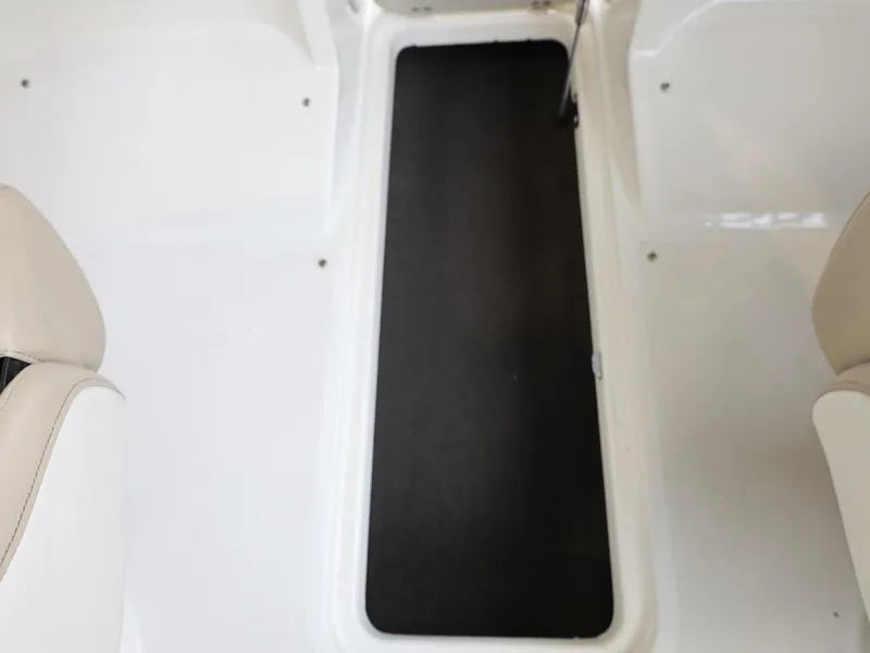 Slide: The Image of 2015 Stingray 198LX boat interior with black floor mat and white seating. - 40