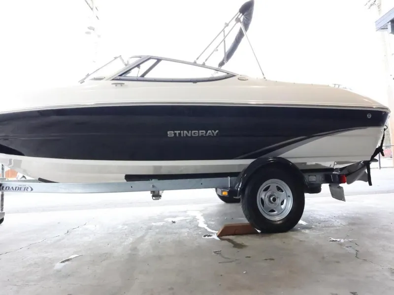 Slide: The Image of 2015 Stingray 198LX boat on trailer, side view in a garage setting. - 5