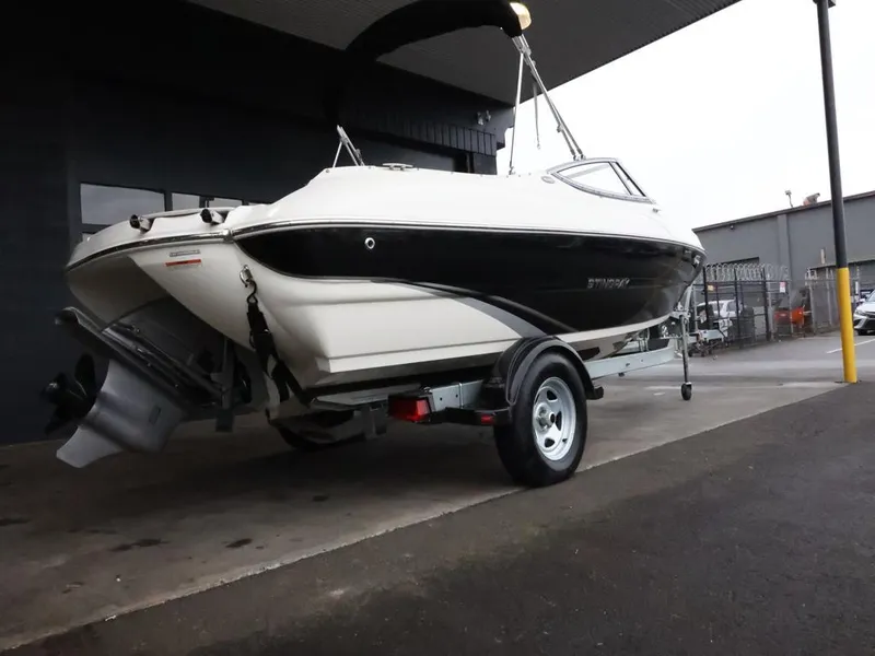 Slide: The Image of 2015 Stingray 198LX boat on trailer, parked in a covered area. - 8