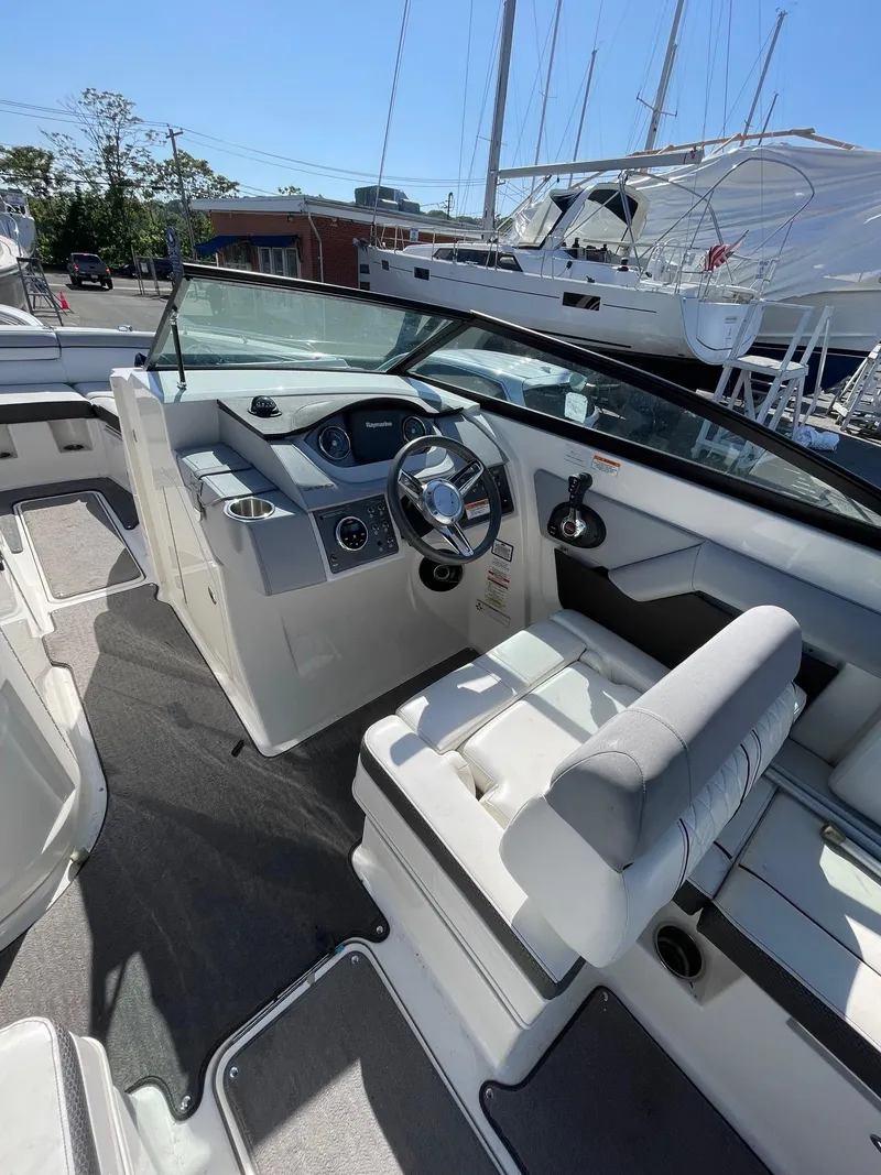Slide: The Image of 2016 Sea Ray 290 Sundeck boat interior with steering wheel and seating. - 12