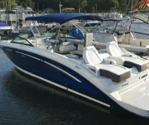 Slide: The Image of 2016 Sea Ray 290 Sundeck boat docked, featuring sleek design and spacious seating. - 2