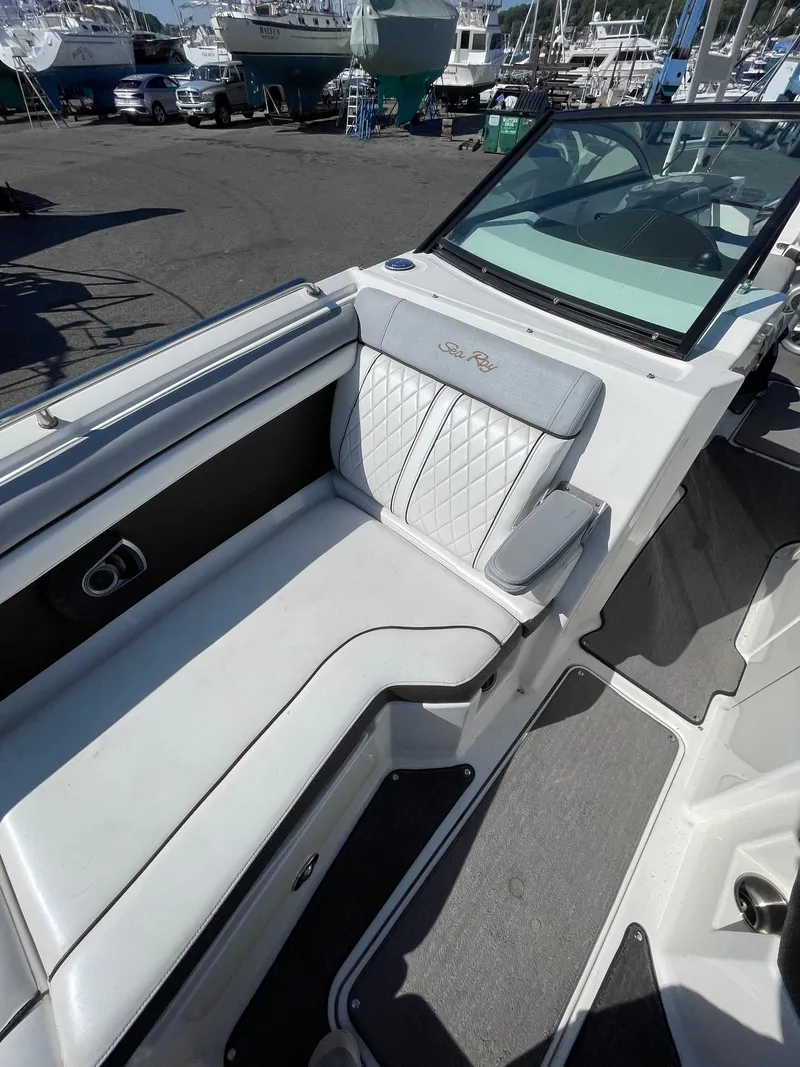 Slide: The Image of 2016 Sea Ray 290 Sundeck boat interior with white seating and modern design. - 20